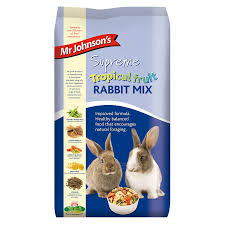 A blue bag of 'Mr Johnsons Supreme Tropical Fruit Rabbit Mix' food with an image of two rabbits and bowl of food.